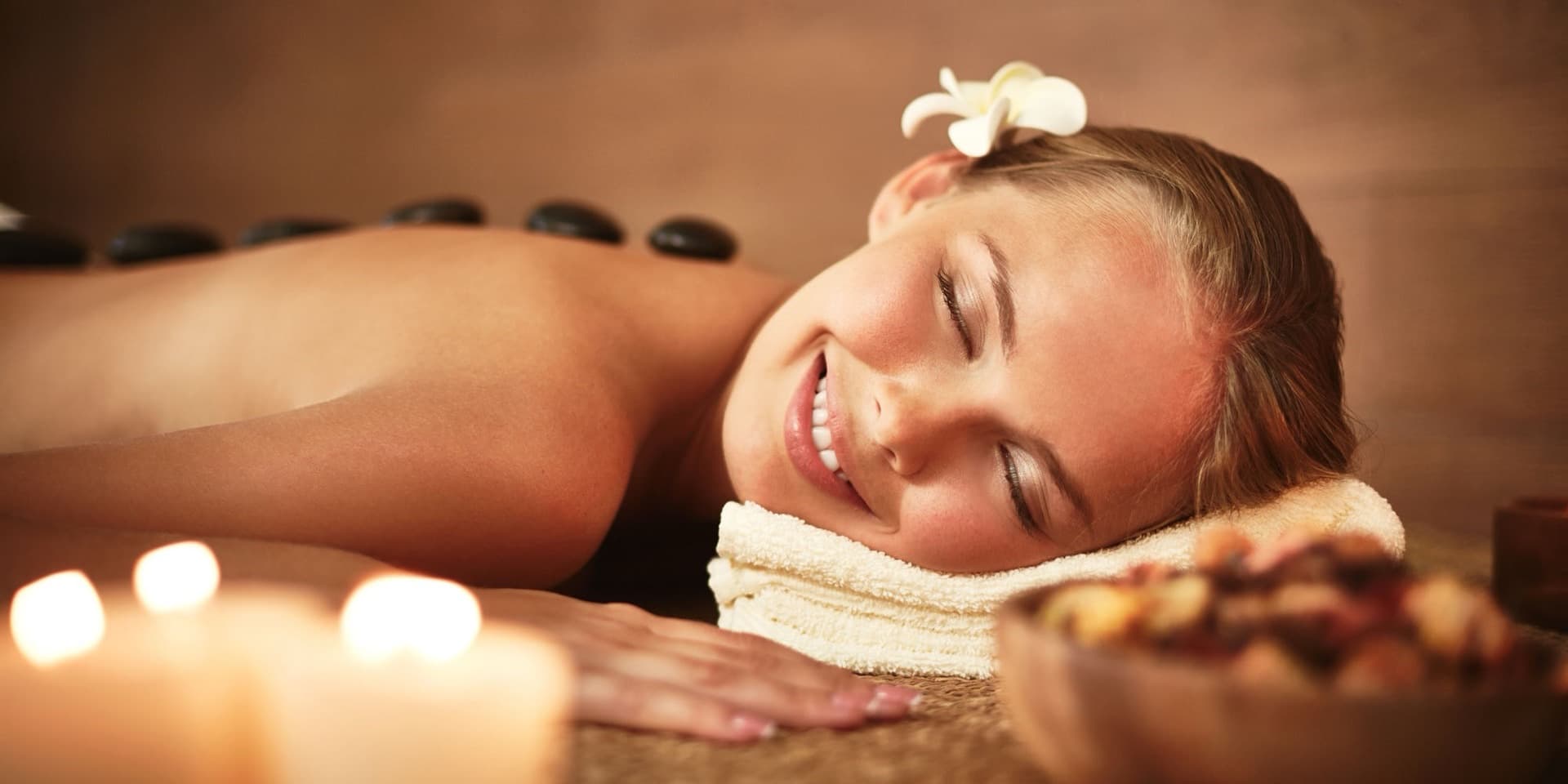 Guest enjoying a hot stone massage at Happy Feet Massage Spa